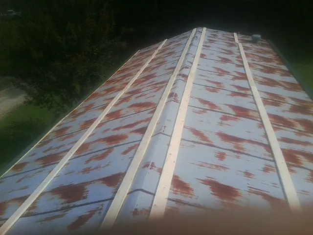 Rusted metal roof panels with new wood purlins before replacement — Storm Damage Roof Repair in Zelienople by Roofing Brothers