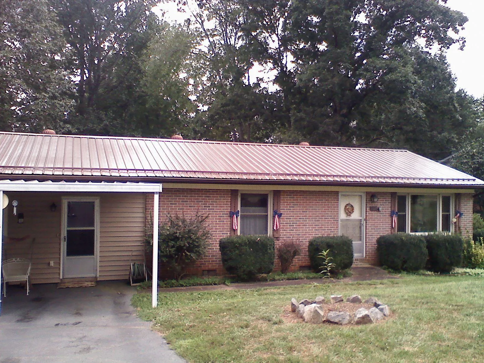 Bronze metal roof and carport on a brick ranch home — Roof Repair work by our crew in Zelienople