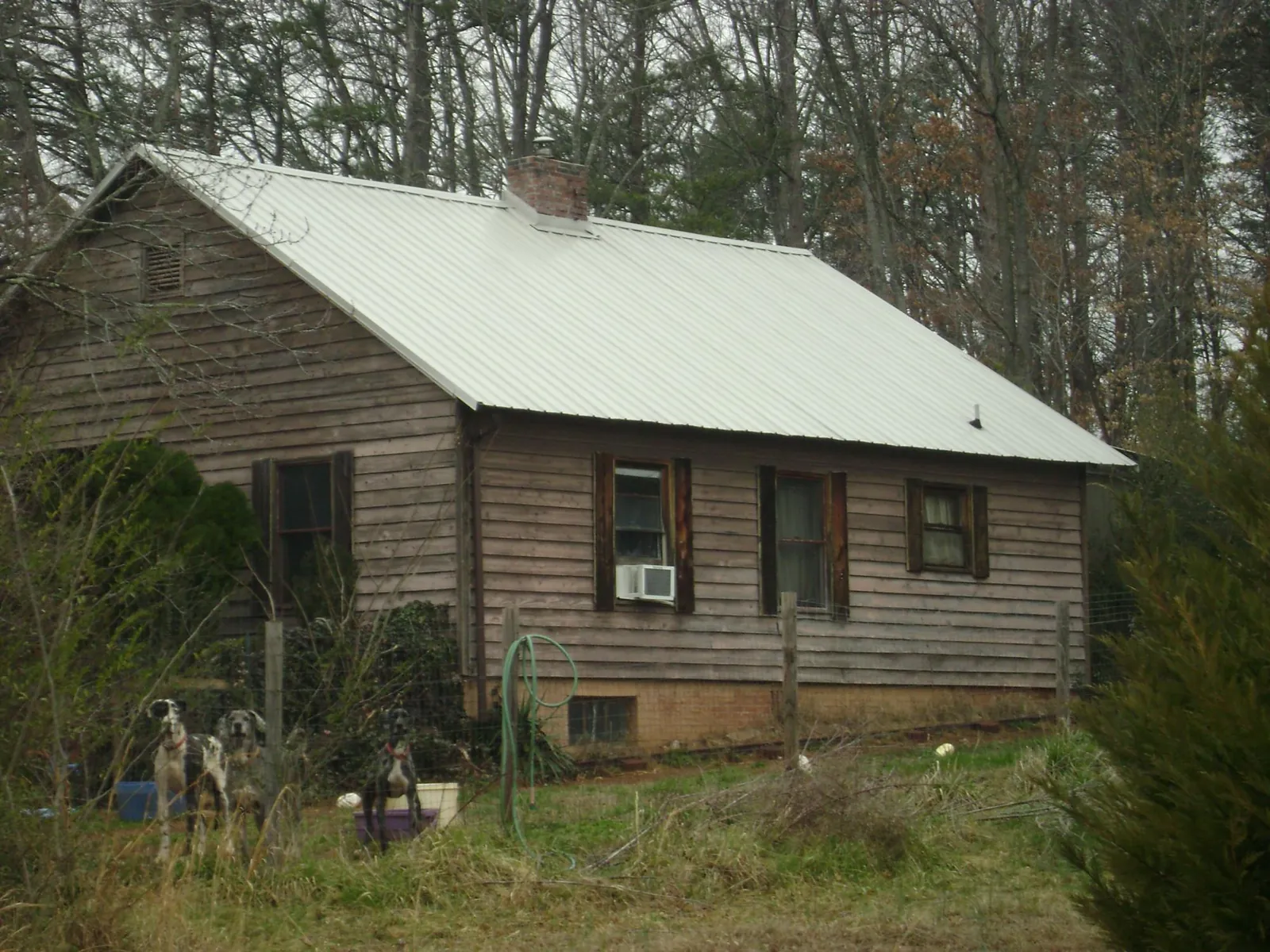 White metal roof on an old wood sided farmhouse, from a Metal Roof Installation job in Zelienople